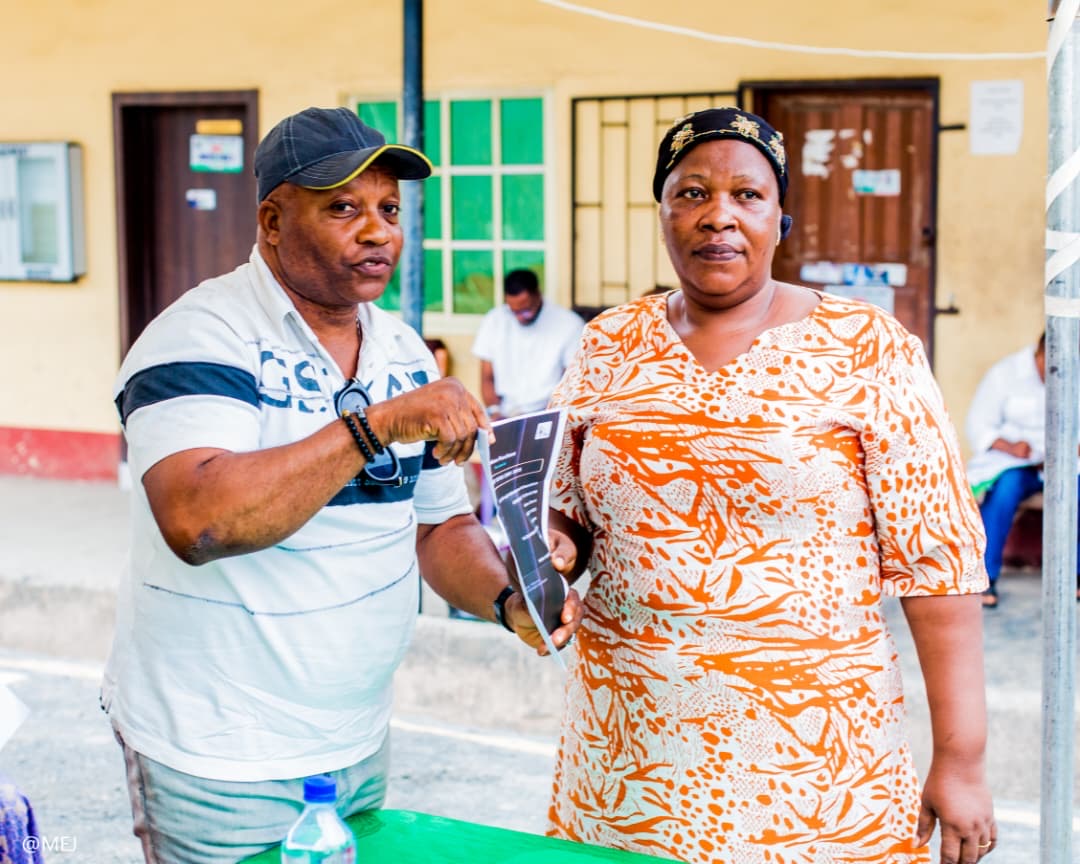 A resident receiving her electricity token document